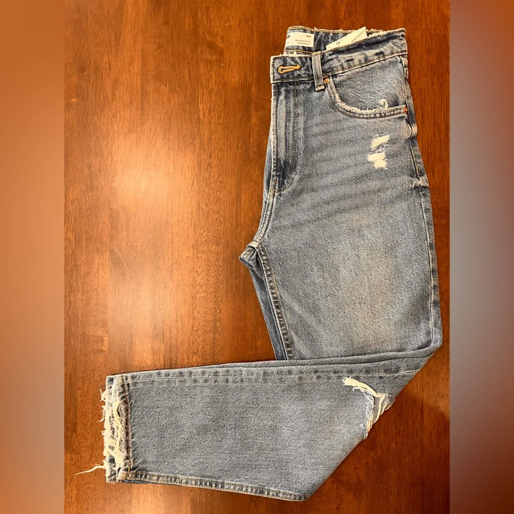 Bershka mom jeans high rise.  with rip in blue. Busted knee Size 4